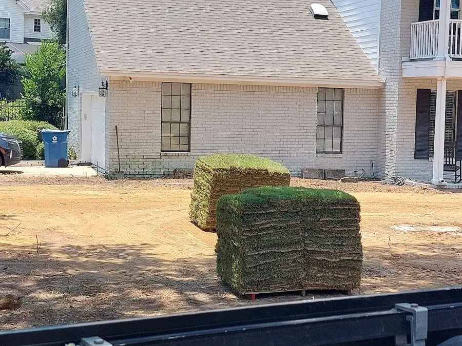Fresh sod pallets on a cleared yard
